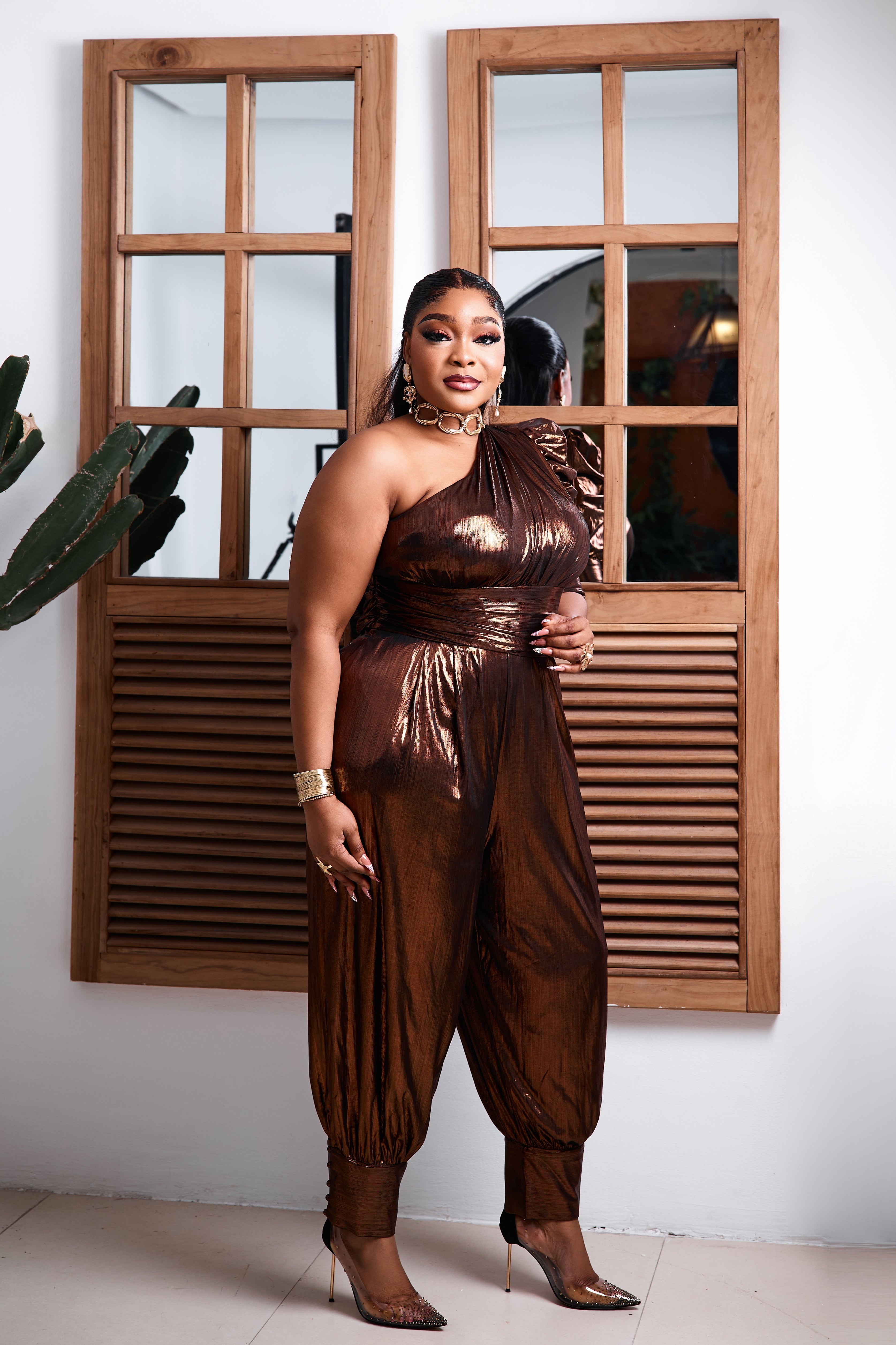 Bronze Goddess jumpsuit by STERA FASHION, featuring a stylish sleeveless design and wide-leg trousers, photographed on a white background.
