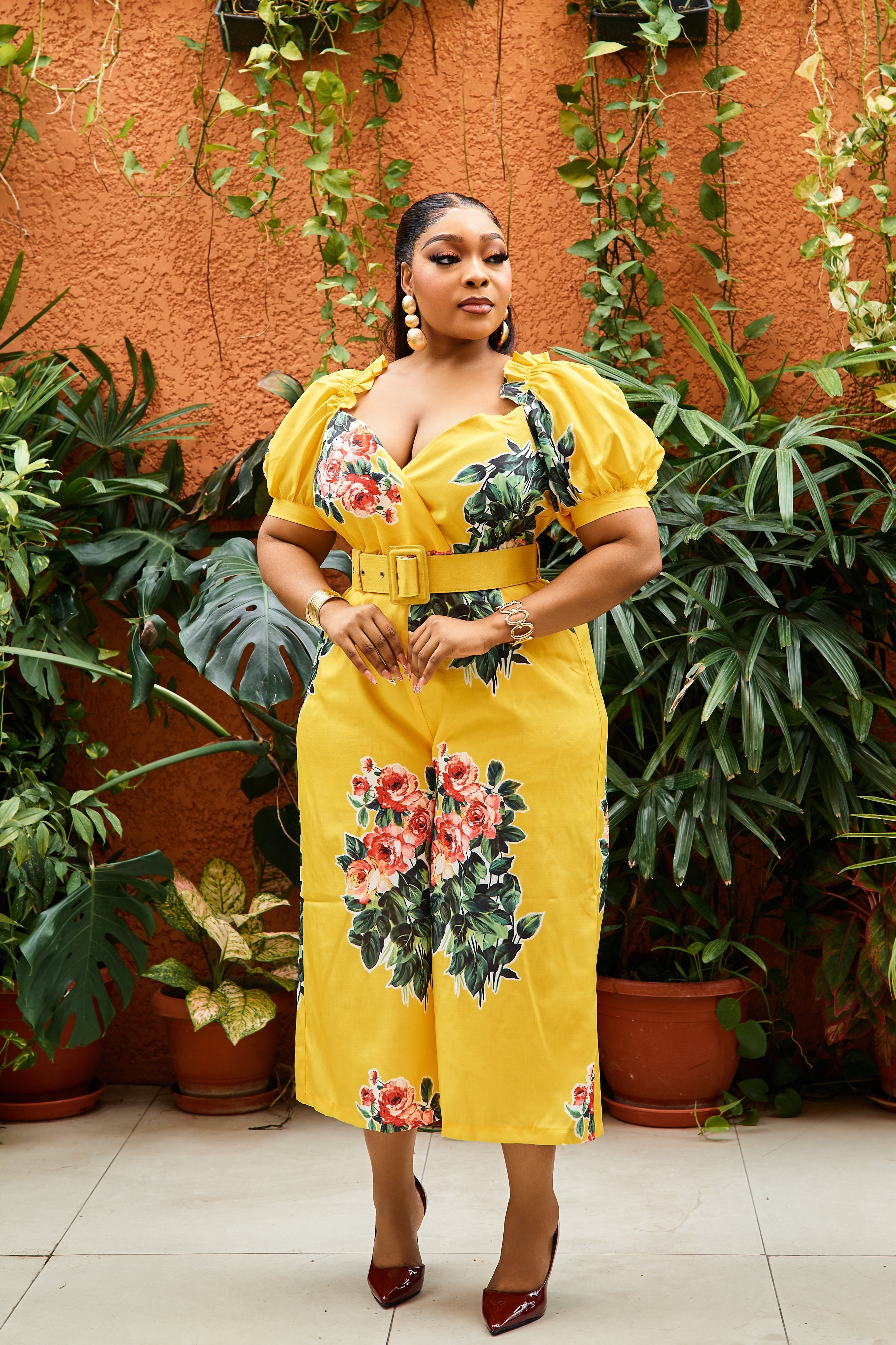 Sterra Fashion Belle Fleur jumpsuit displayed on a hanger, featuring a stylish floral pattern and wide-leg design.