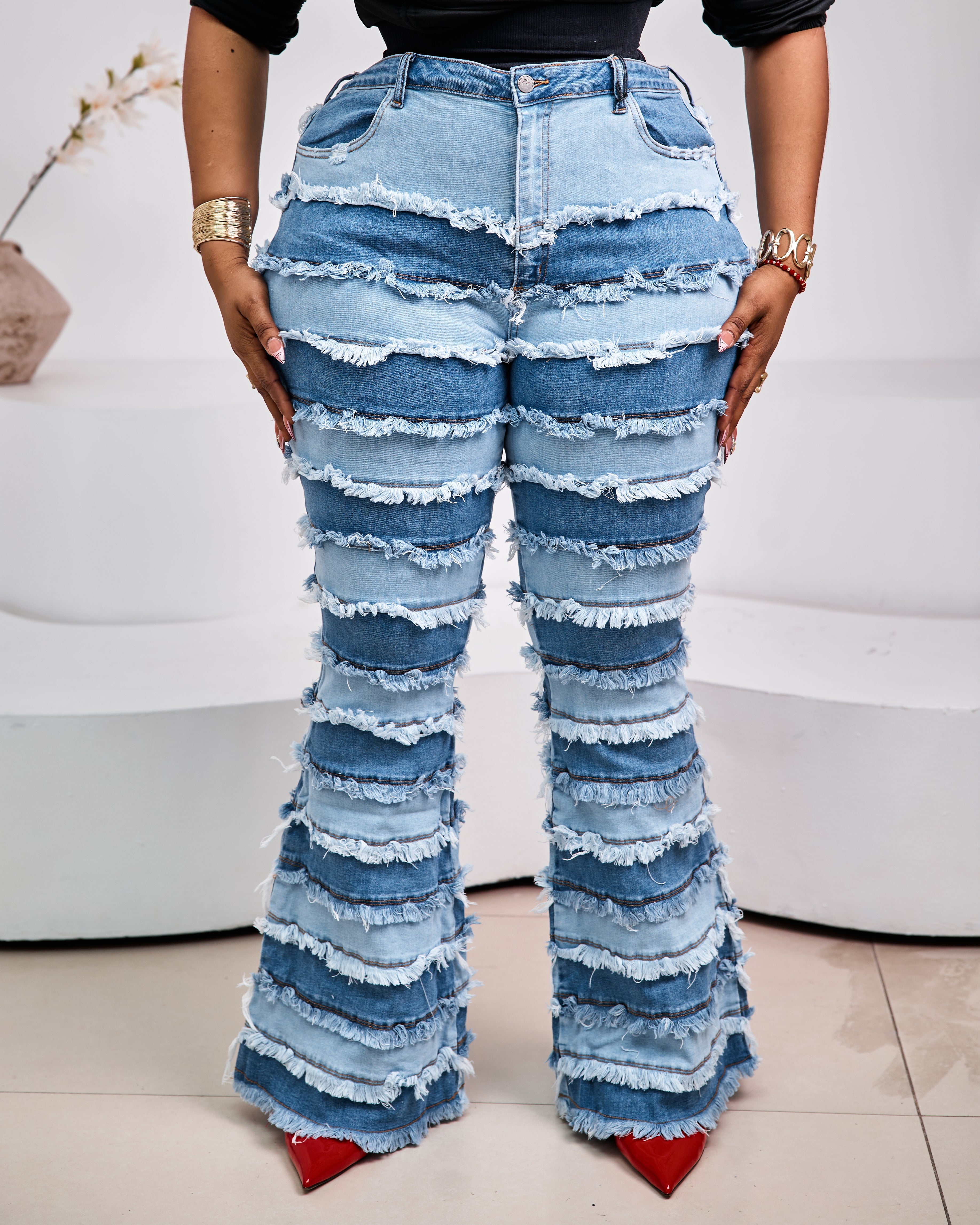 Sterra Fashion Milan Fringe Denim Jeans with stylish fringe details, shown on a model with a casual urban background.