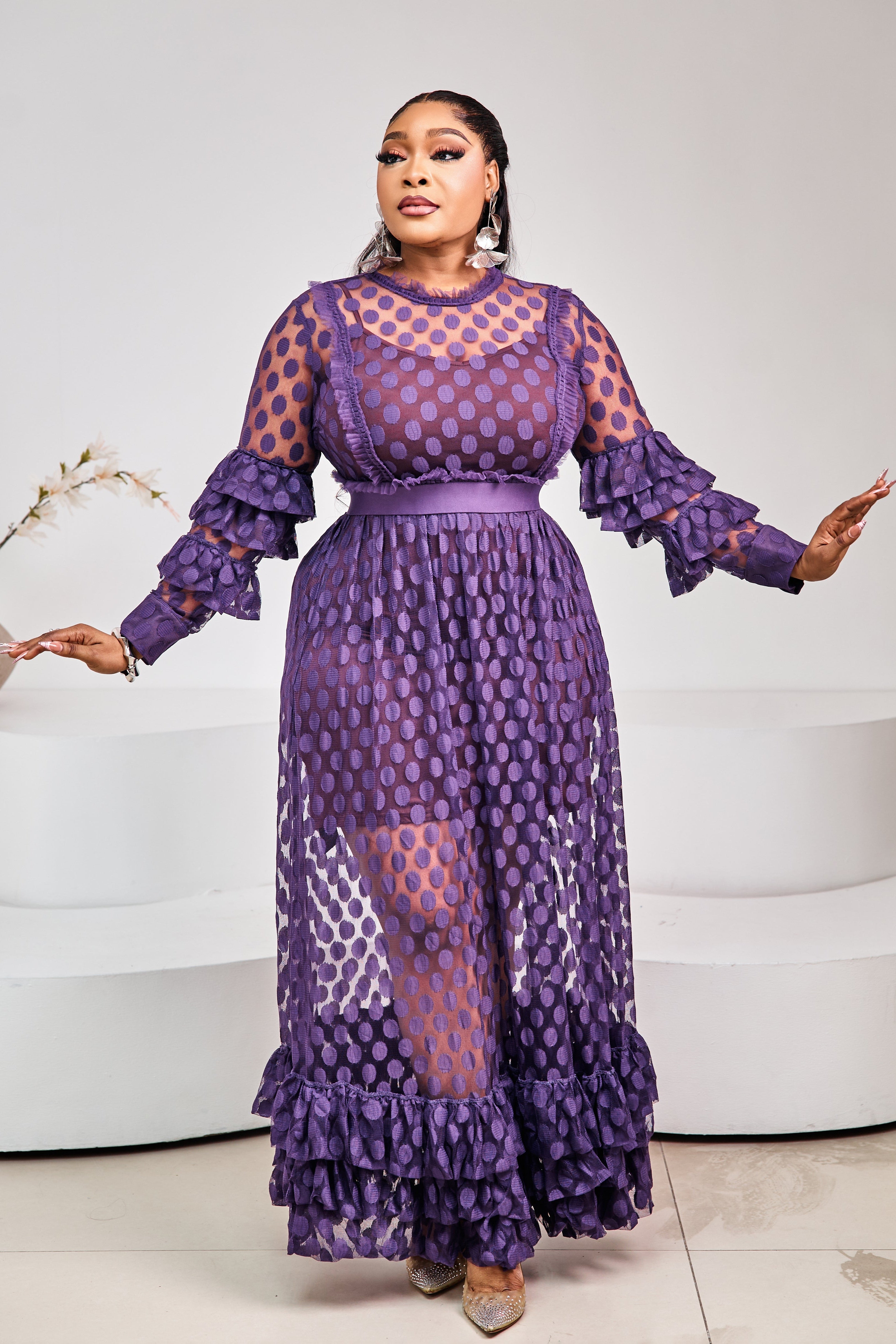 Sterra Fashion Tropez Elegance Dress displayed on a hanger, featuring a stylish design with flowing fabric and intricate details.