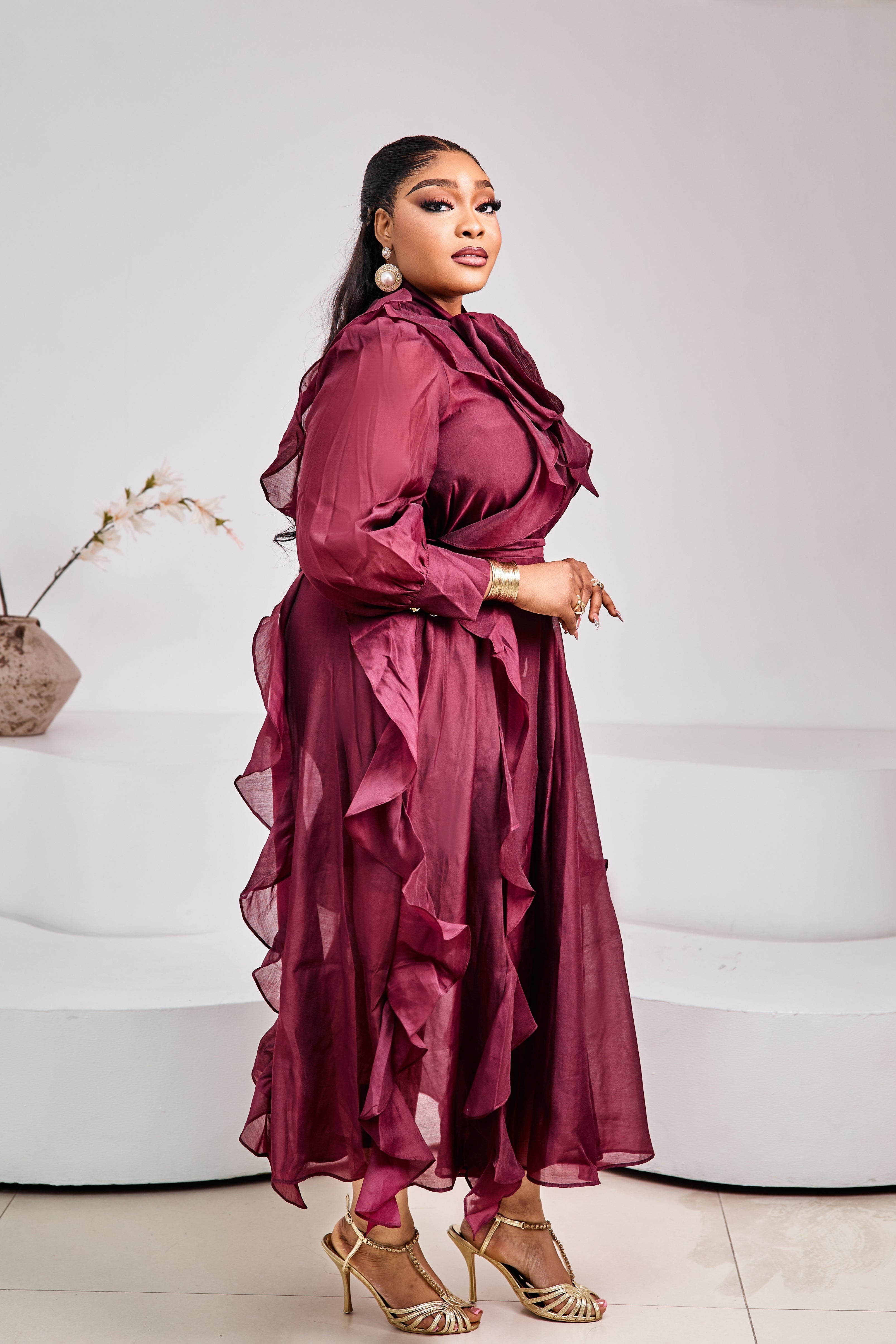 Tuscan Bordeaux Ruffle Dress by STERA FASHION, featuring flowing fabric and ruffled details, displayed on a mannequin.