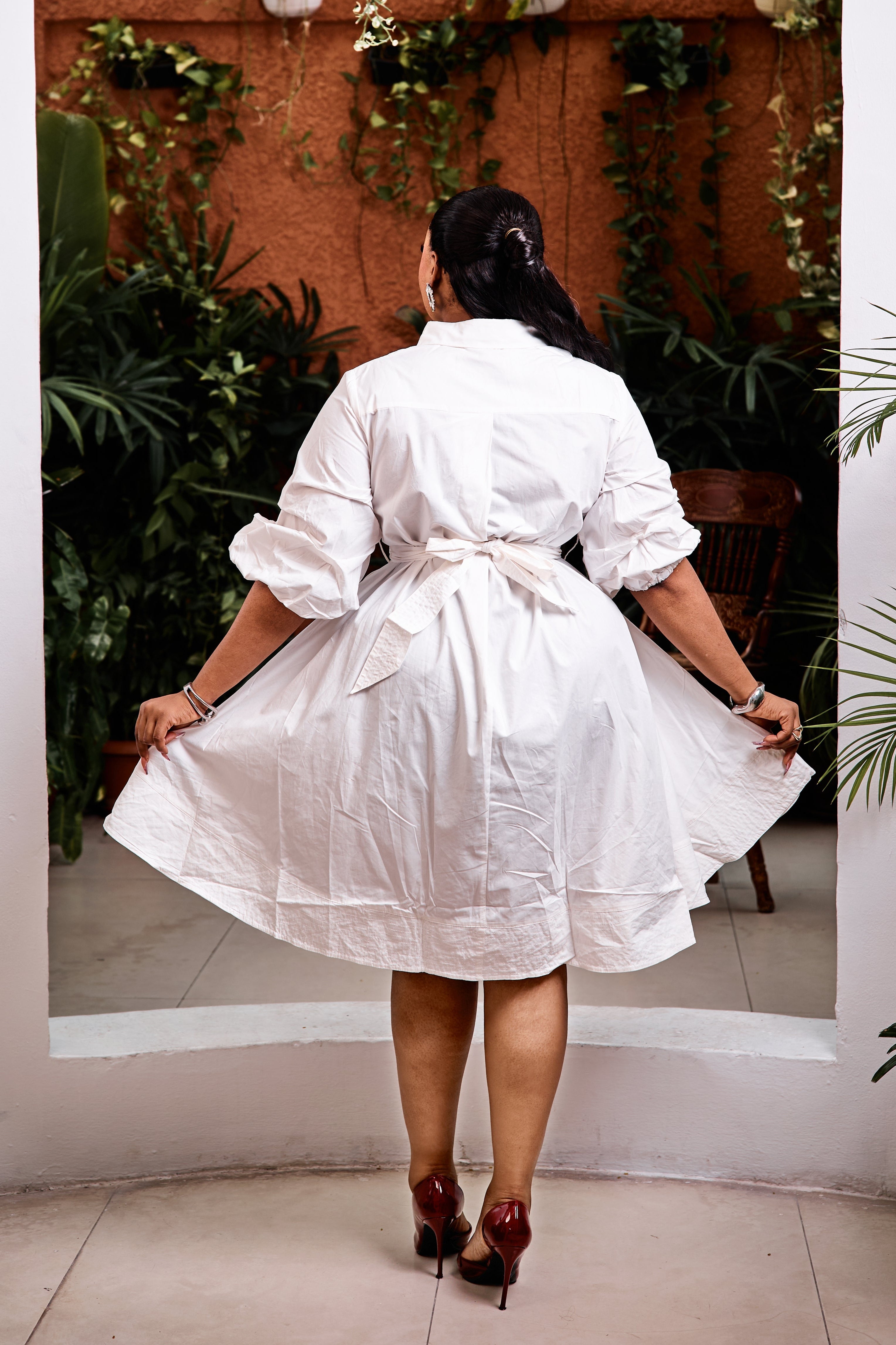 Sterra Fashion Capri Bella high-low dress in flowy fabric, featuring a fitted bodice and layered hemline, displayed on a dress form.