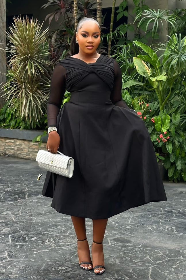 Sterra Fashion Reverie Dress featuring a flowy fabric and elegant design, displayed on a hanger or worn by a model.