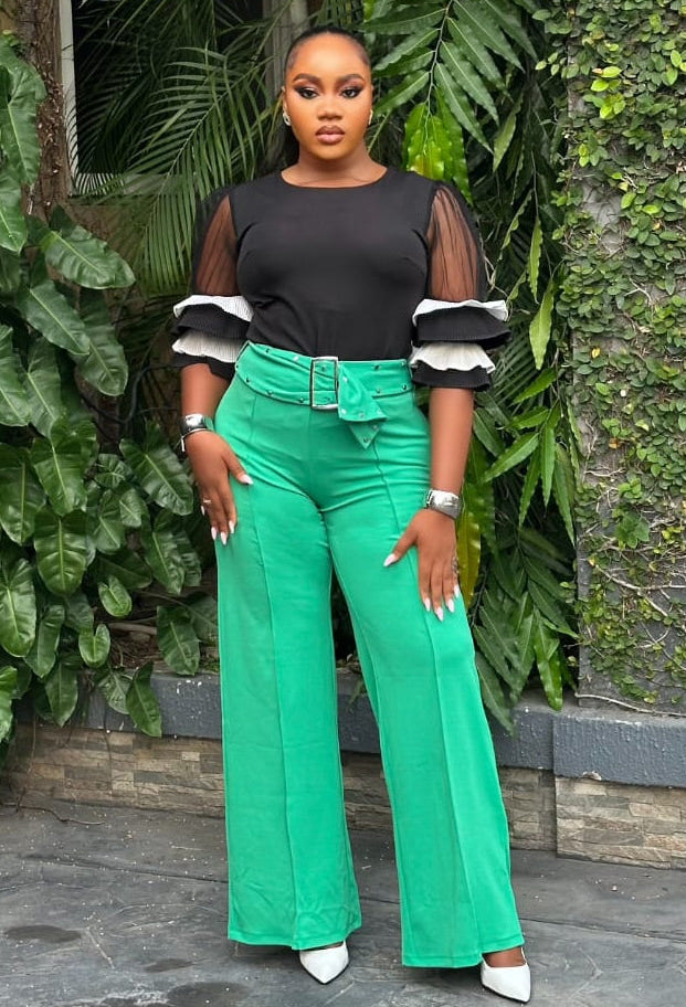 Emerald green STERA FASHION Poise pant with tailored fit, showcased on a model, featuring sleek design and comfortable fabric.