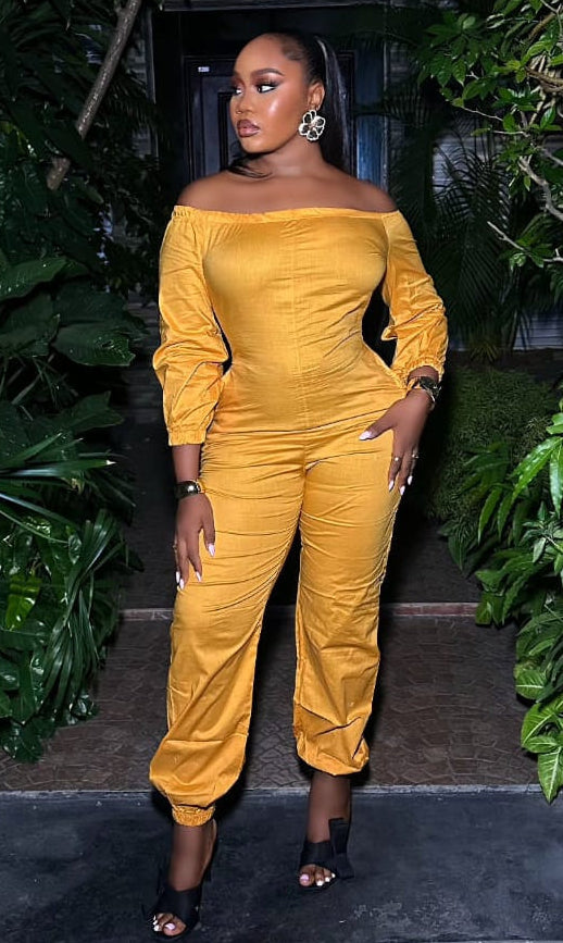 Saffron Aura STERA FASHION jumpsuit with wide legs and sleeveless design, displayed on a hanger against a neutral background.