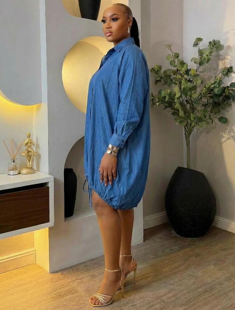 Light blue denim oversize shirt dress from STERA FASHION BOUTIQUE with long sleeves and collar, casual and comfortable style.