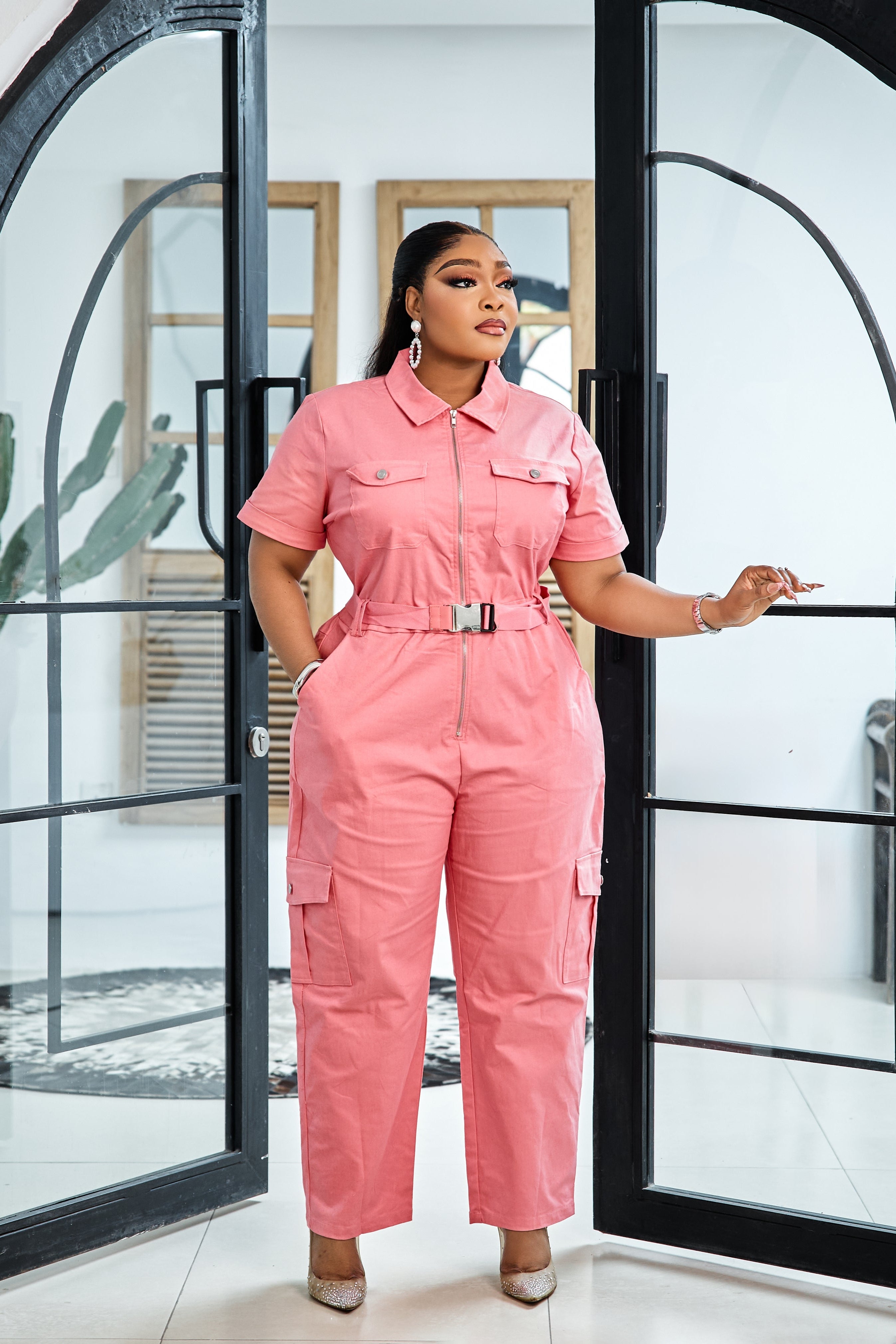 Sterra Fashion Blush Luxe Jumpsuit displayed on a model, featuring a stylish, elegant design with a fitted waist and wide-leg pants.