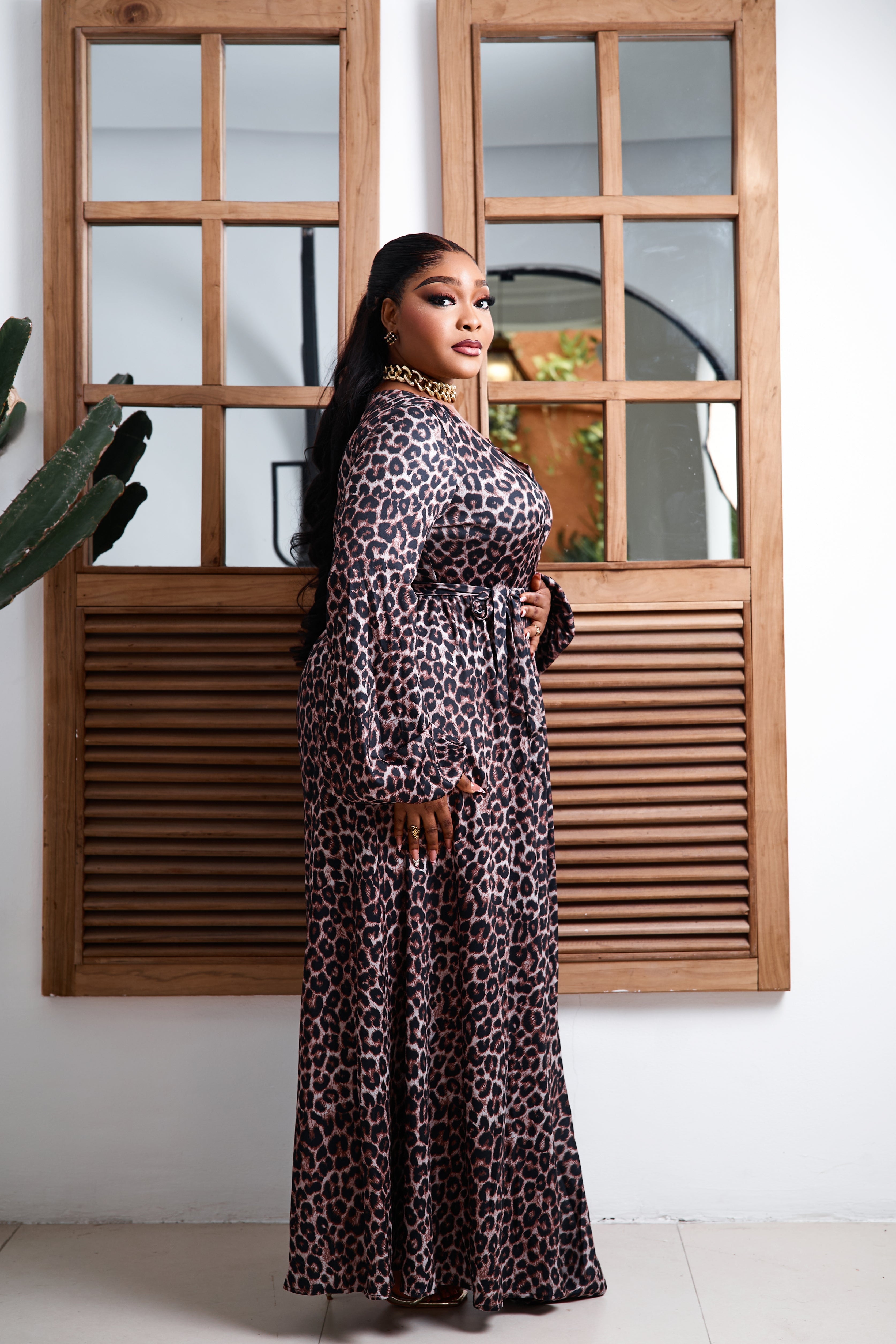 Sterra Fashion Savannah Royale Maxi Dress displayed on a hanger with flowing fabric and elegant design in a well-lit setting.