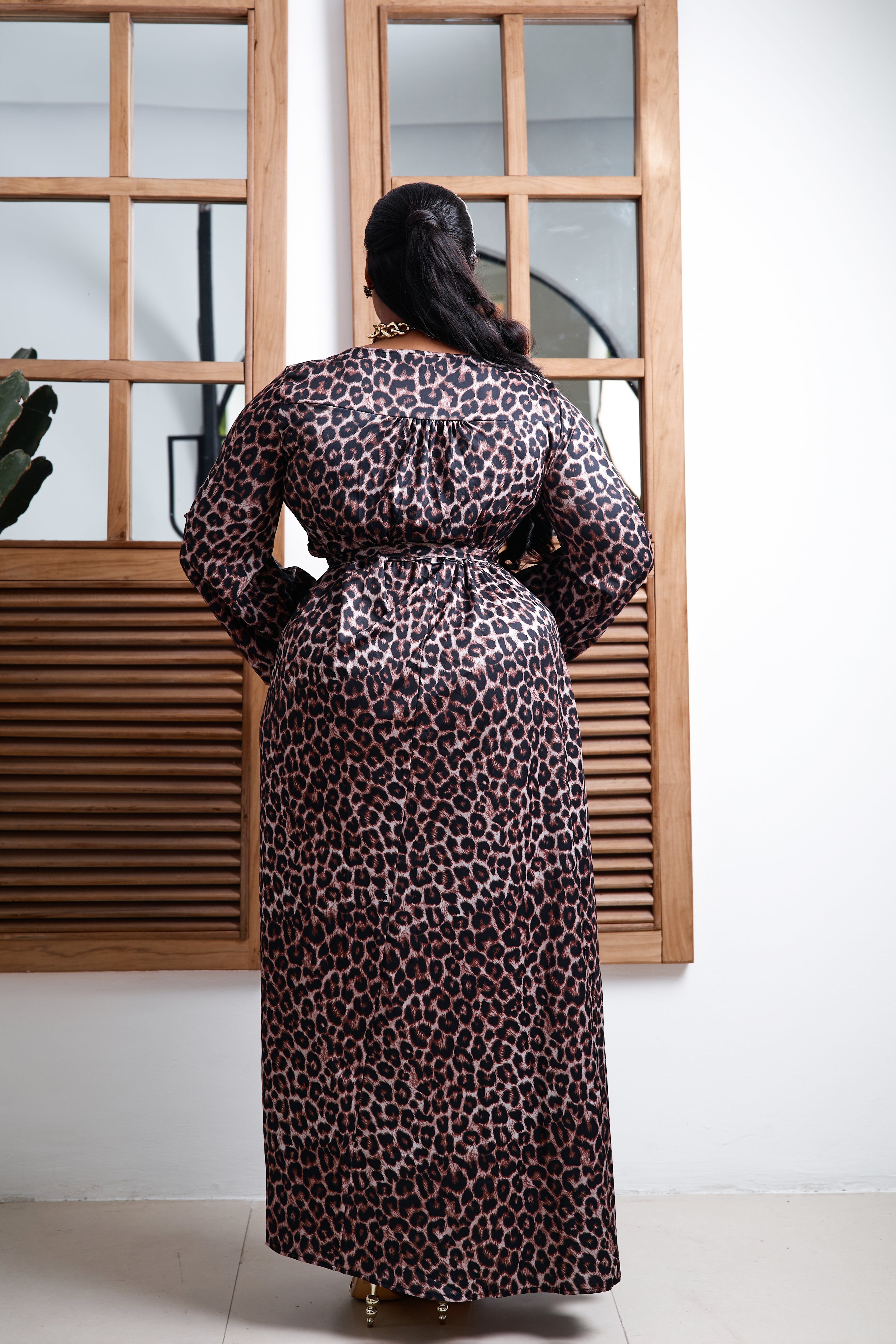 Sterra Fashion Savannah Royale Maxi Dress displayed on a hanger with flowing fabric and intricate design details.