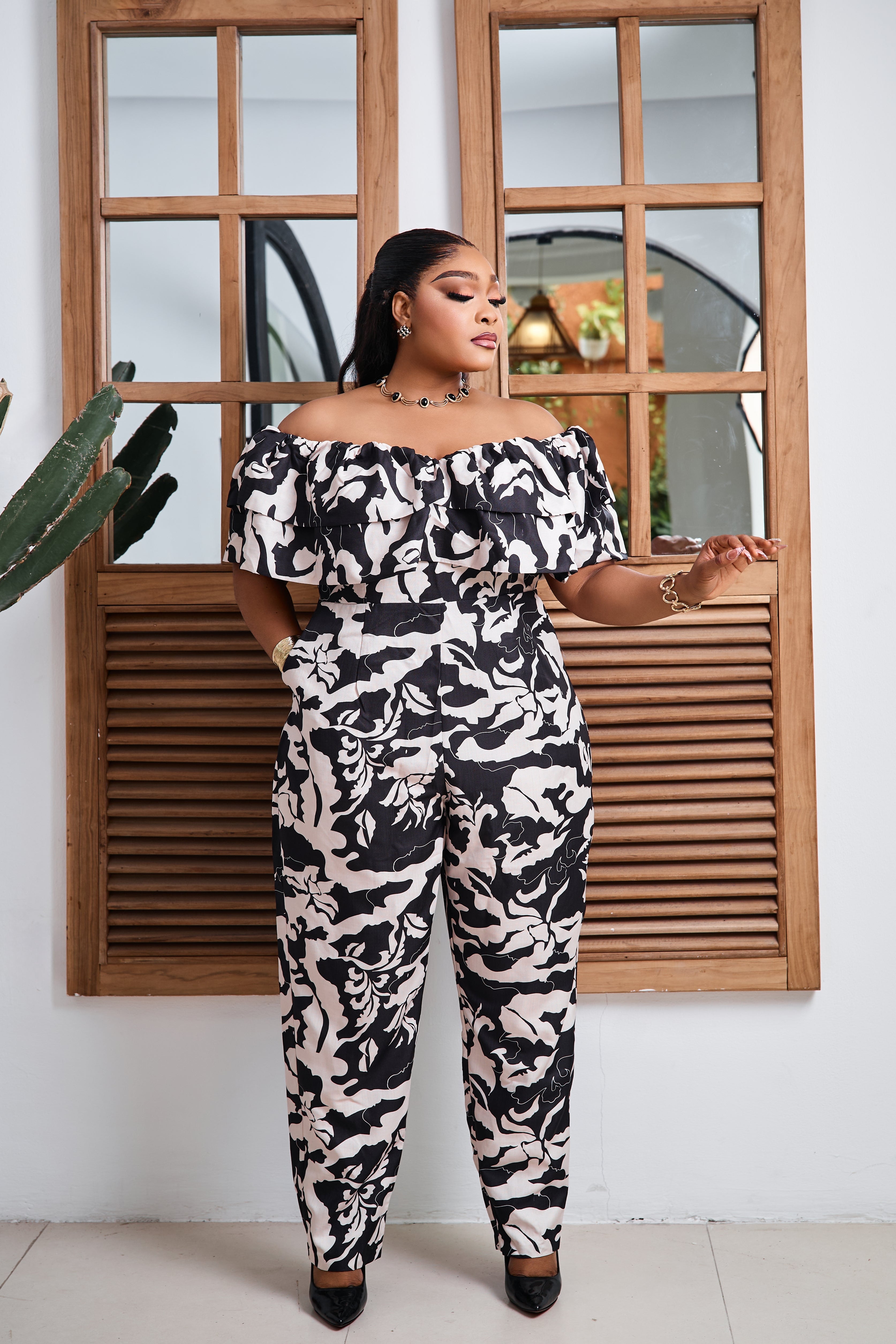 Sterra Fashion Maison Élysée jumpsuit displayed on a hanger, featuring a sleek, modern design with a fitted silhouette and stylish fabric.