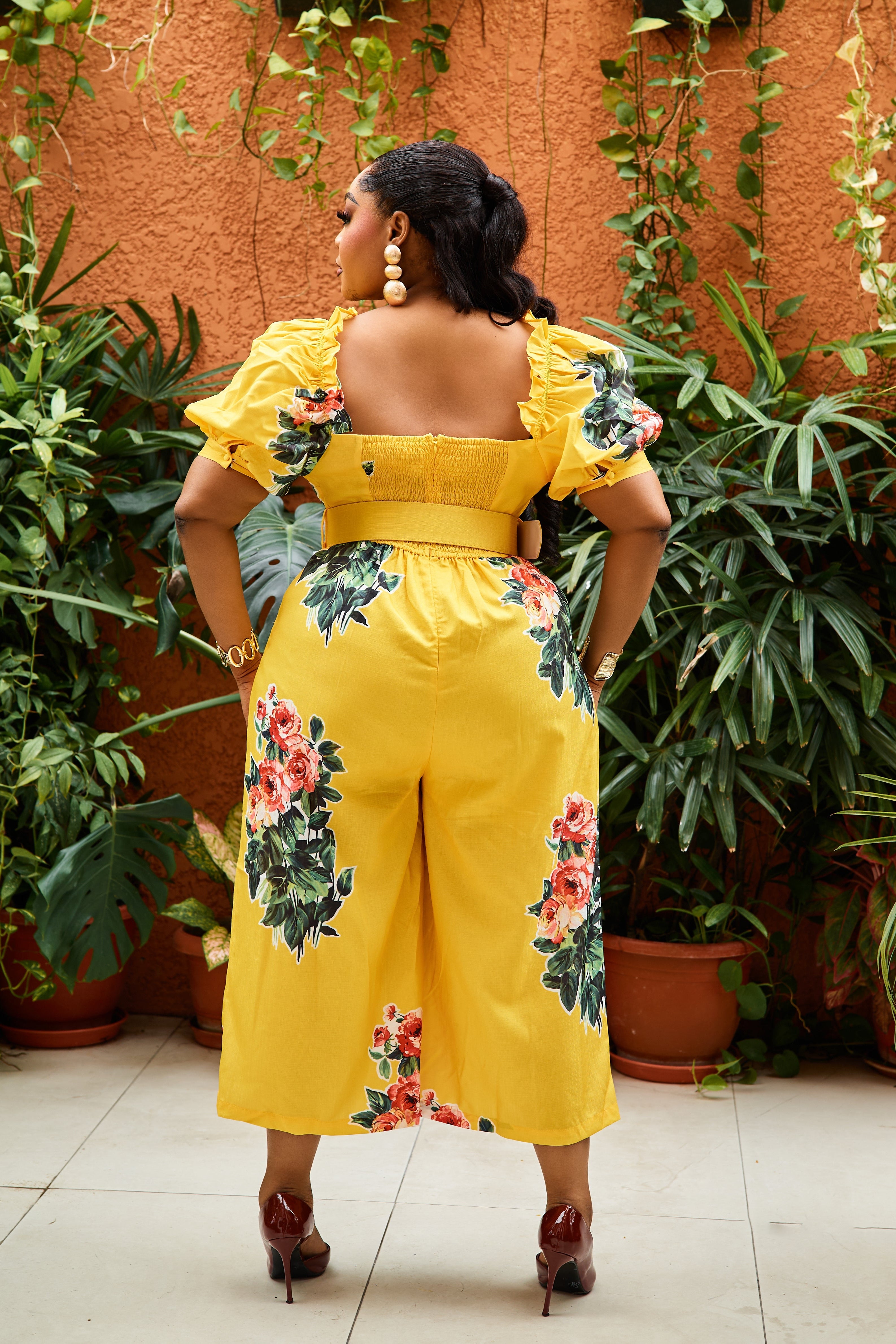Sterra Fashion Belle Fleur jumpsuit with floral pattern, sleeveless design, and wide-leg pants, displayed on a hanger.