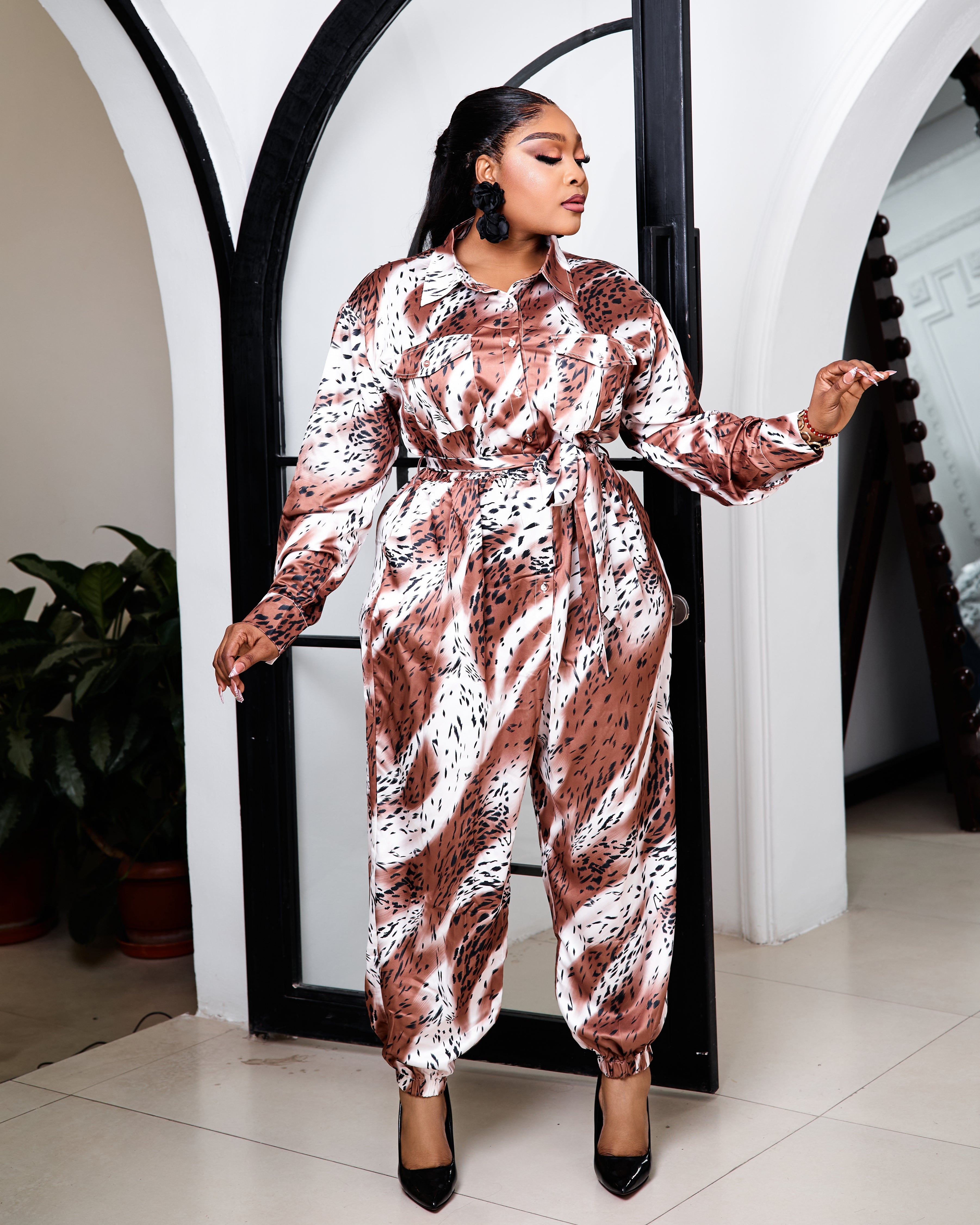 Sterra Fashion Boutique Glamour Capri Jumpsuit displayed on a hanger with a fitted design and stylish details.