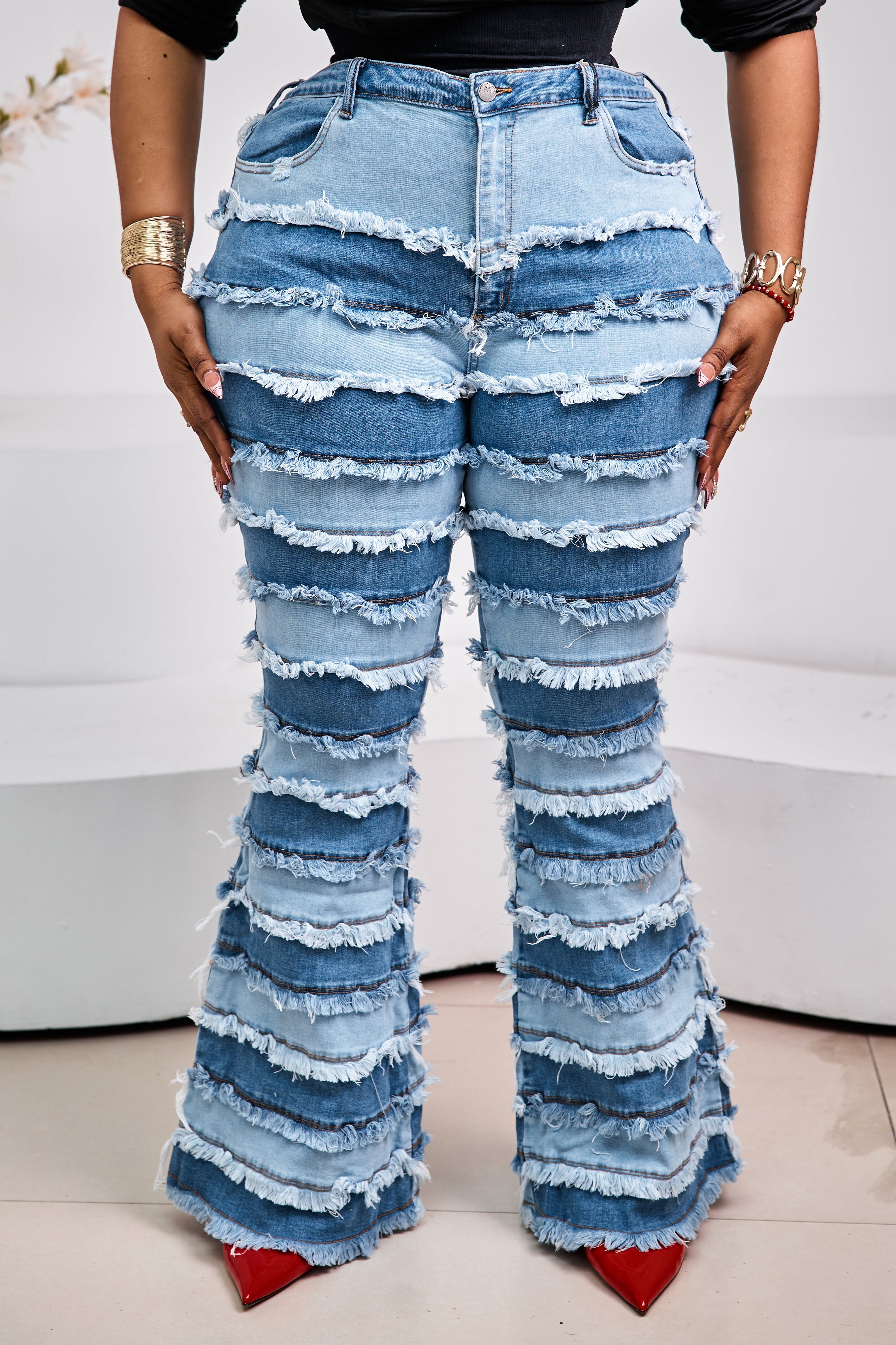 Sterra Fashion Milan Fringe Denim Jeans with stylish fringe details, shown on a model with a casual urban background.