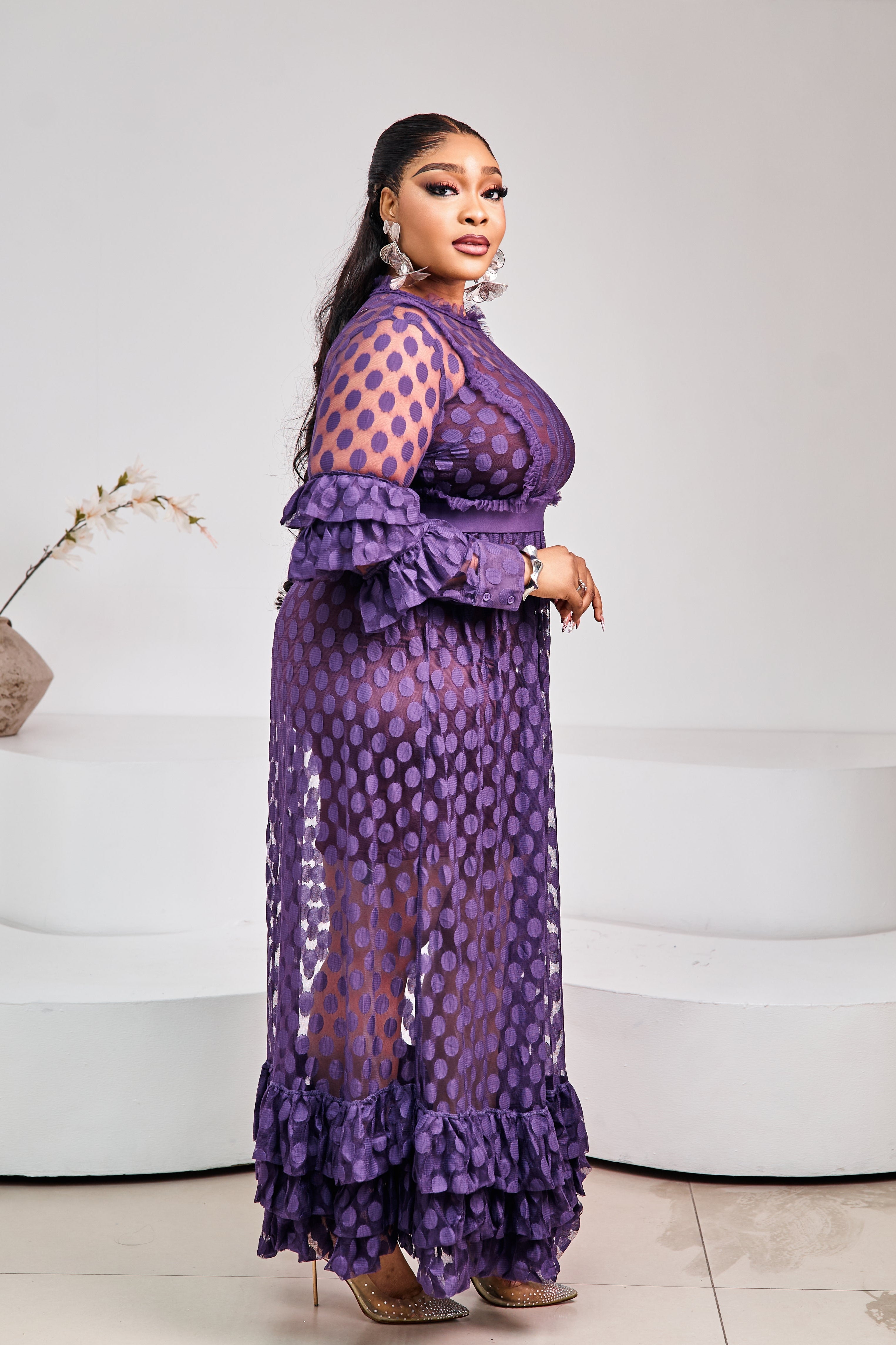 Sterra Fashion Tropez Elegance Dress displayed on a hanger, featuring a flowy design and intricate details.