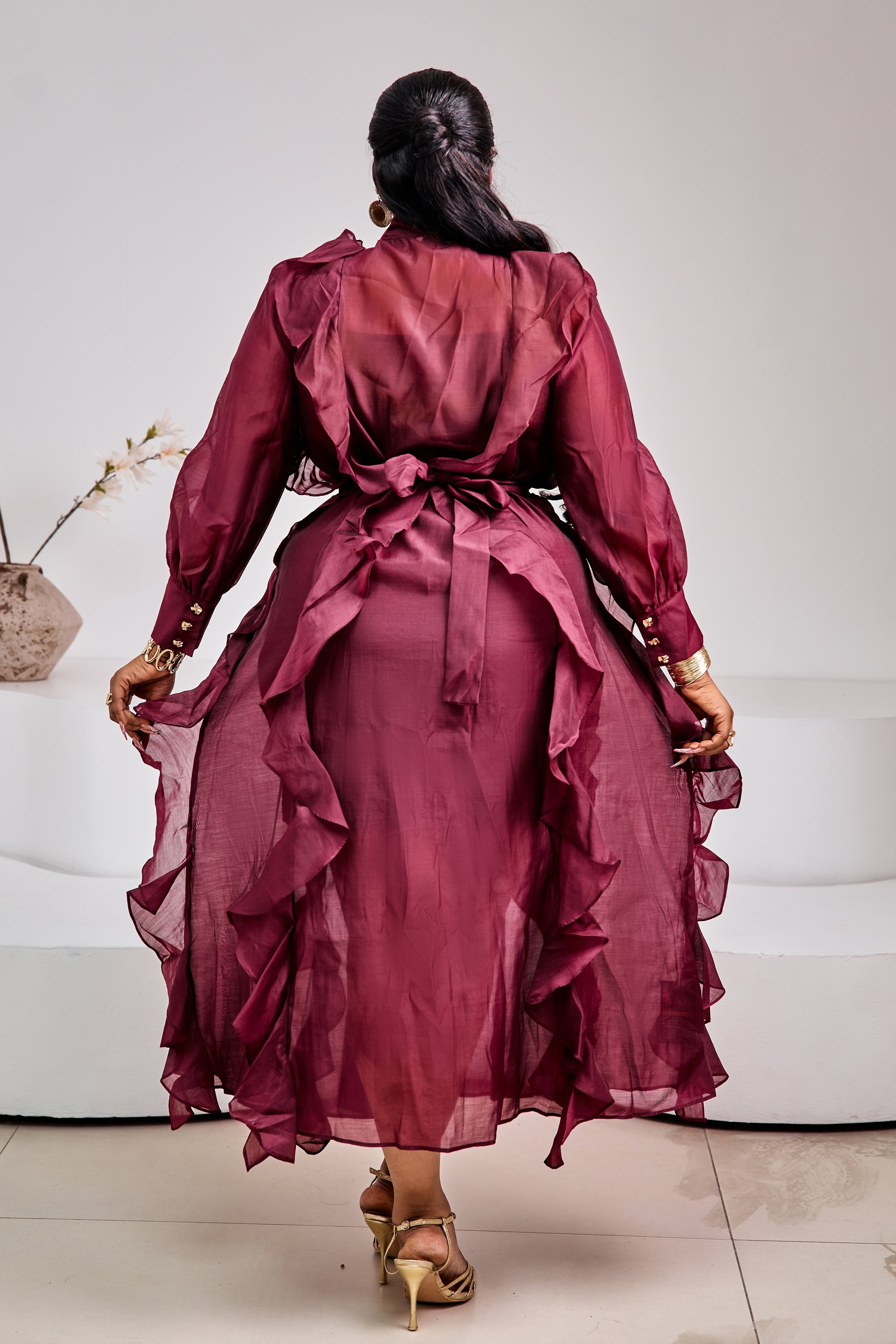 Tuscan Bordeaux Ruffle Dress by STERA FASHION, featuring flowing fabric and ruffle details, displayed on a mannequin.