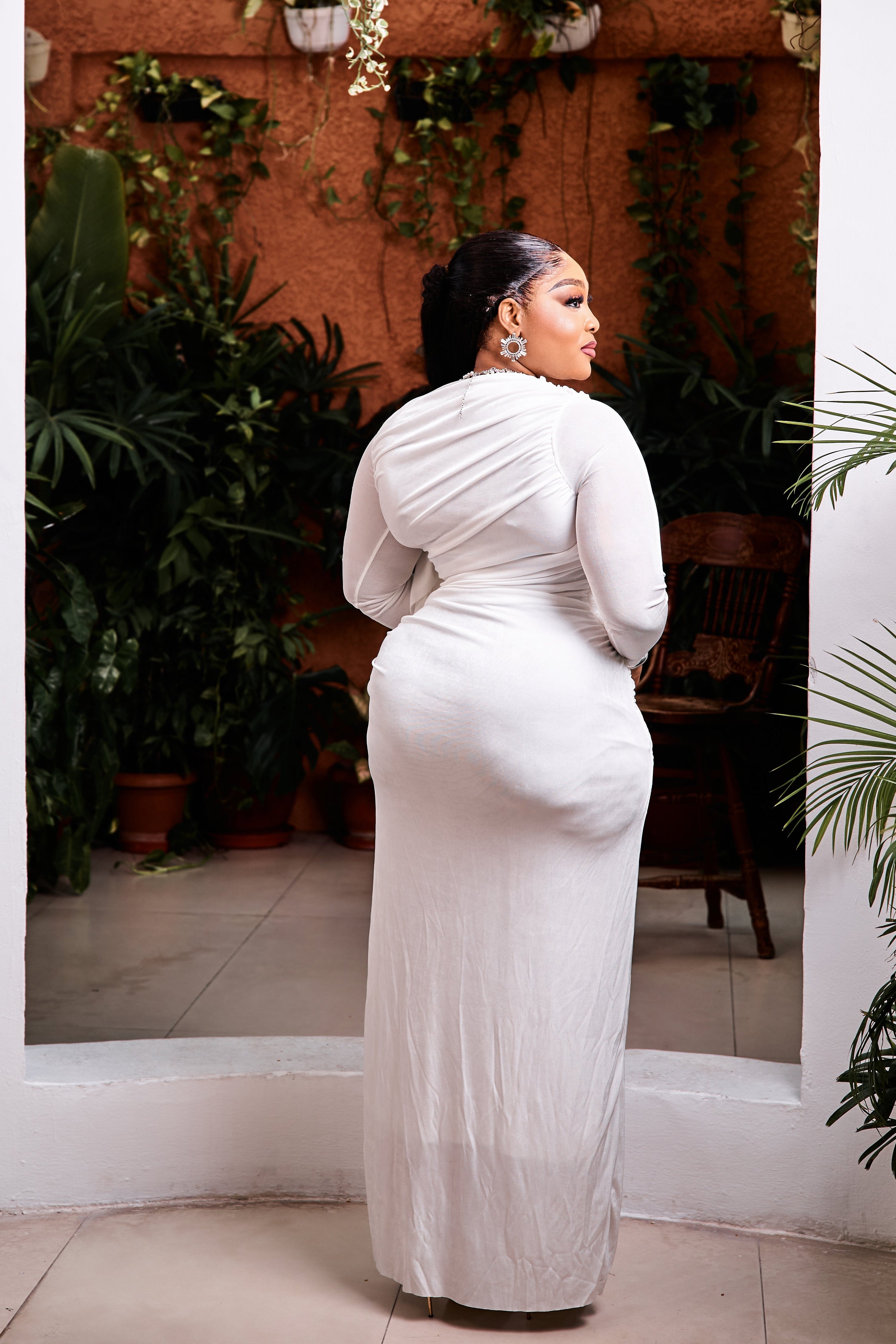 Elegant Opaline Royale gown by STERA FASHION showcased on a hanger with intricate details and flowing fabric.