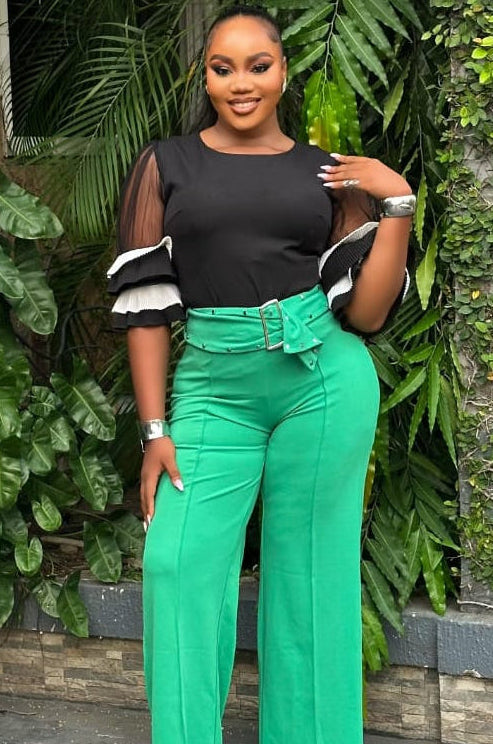 Emerald green STERA FASHION Poise pant with tailored fit and sleek design, shown on a model against a neutral background.