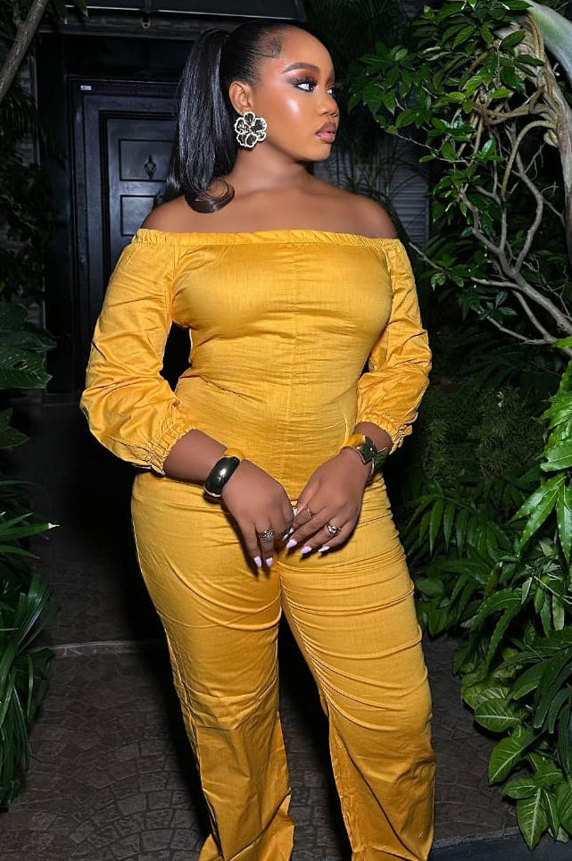 Saffron Aura STERA FASHION jumpsuit with wide legs and sleeveless design, displayed on a hanger against a neutral background.