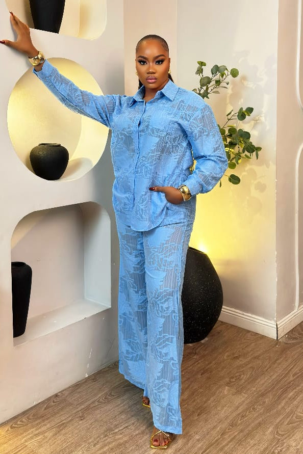 Sterra Fashion Bleu Élise set featuring stylish blue clothing with intricate design details, displayed on a flat surface.