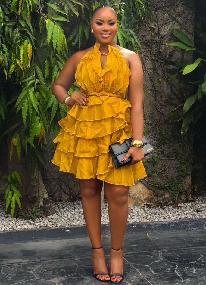 Amber Ruelle Dress by STERA FASHION, featuring a flowing silhouette with intricate amber-toned fabric and elegant design.