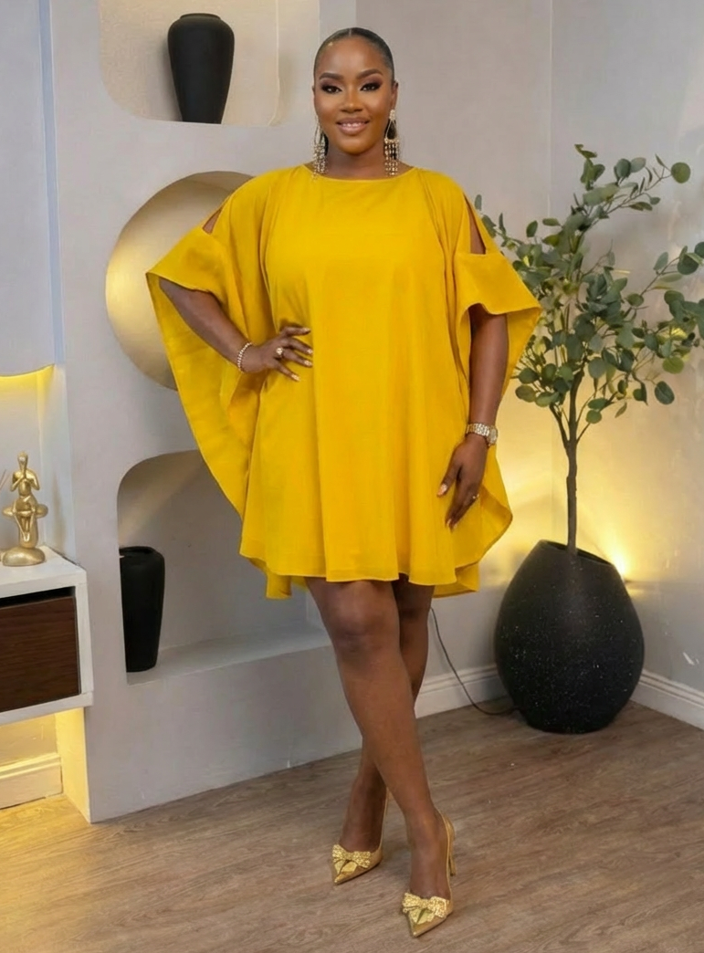 Golden Aura Cape Mini Dress by STERA FASHION BOUTIQUE featuring a stylish golden cape detail and a fitted mini dress silhouette.