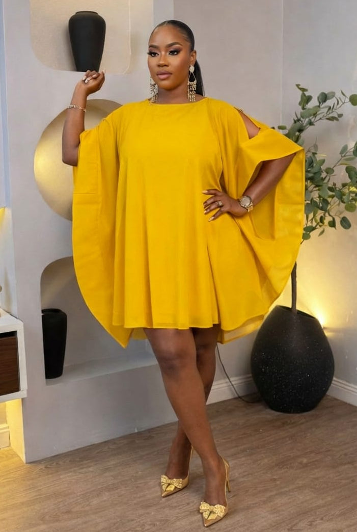 Golden Aura Cape Mini Dress by STERA FASHION BOUTIQUE featuring a shimmering gold fabric, cape detail, and stylish mini length.