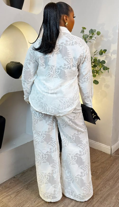 Ivory Élise set by STERA FASHION, featuring elegant matching top and skirt with stylish details on a plain background.