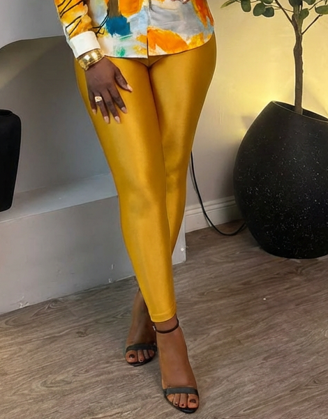 Golden brushstroke satin blouse and marigold luxe sculpt leggings from STERA FASHION BOUTIQUE, styled together in a fashionable outfit.